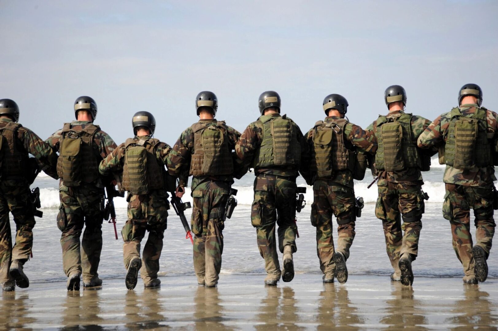 fm=f_20617 A group of soldiers walking along the beach.