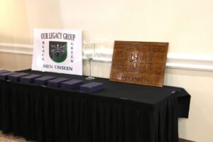 A table with several plaques and a sign on it.