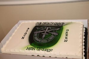 A cake with the crest of the legacy group.