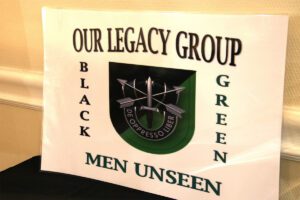 A sign that says our legacy group black green men unseen.