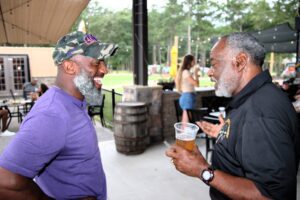 Two men talking to each other at an outdoor event image