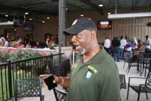 A man in a green shirt talking on a cell phone in color