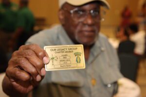 A man holding up his gold card.