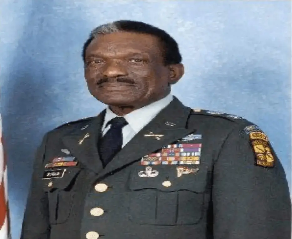 A man in military uniform is standing up.