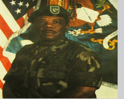 A man in uniform standing next to an american flag.
